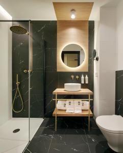 a bathroom with a sink and a toilet and a mirror at Gran Zubieta La Concha in San Sebastián