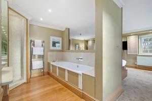 a large bathroom with a tub and a sink at Slebech Park Estate in Wiston