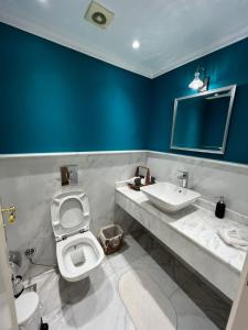 a bathroom with a toilet and a sink at Large Luxurious Apartment in Cairo