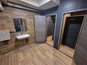 a bathroom with a sink and a shower at Apartmani New York in Nova Gradiška +27 photos