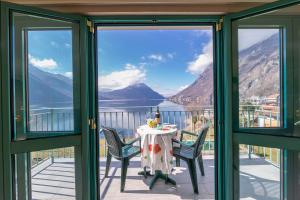 a view from the balcony of a house with a table and chairs at Residence Porto Letizia - Happy Rentals in Porlezza