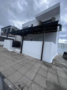 a white wall with awning on the side of a house at Jacks Apartment in Paphos City