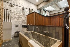 a bathroom with a large tub in a room at Slebech Park Estate in Wiston