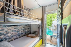 a room with two bunk beds and a balcony at Casa Barcelo Camp Nou Barcelona in Hospitalet de Llobregat