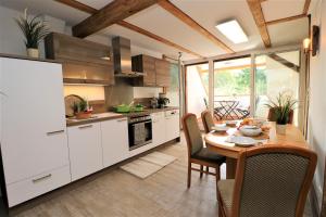a kitchen with a wooden table and a dining room at Ferienwohnung Krull in Wustrow