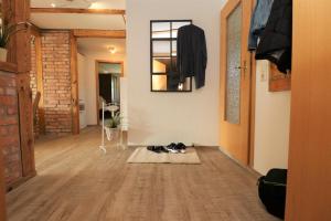 a room with a hallway with wooden floors and a mirror at Ferienwohnung Krull in Wustrow +30 photos