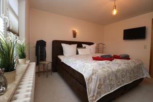 a bedroom with a bed with two red towels on it at Ferienwohnung Krull in Wustrow