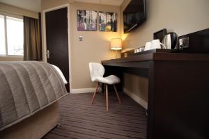 a hotel room with a bed and a desk at Silurian Hotel Newport in Newport