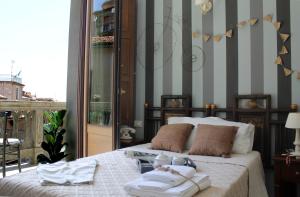 a bedroom with a bed with towels on it at Albergo Merùo in Morano Calabro