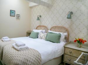 a bedroom with a large bed with towels on it at Regent House deluxe 2 bedroom apartment in Harrogate