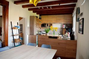 a kitchen with wooden cabinets and a table and chairs at La Belle Rochette in Bouessay
