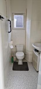 a bathroom with a toilet and a sink and a window at Frank’s and Chong’s excellent location in Amsterdam