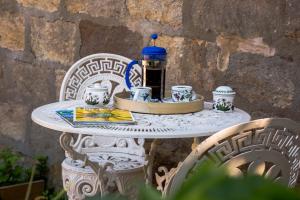 a white table with cups and a bottle on it at Cold Cotes Harrogate in Harrogate