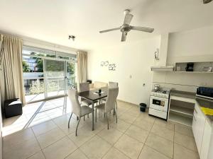a kitchen with a table and chairs in a room at Venezia Aparts in Colón