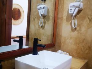 a bathroom with a sink and a mirror at SBH Monica Zanzibar in Paje
