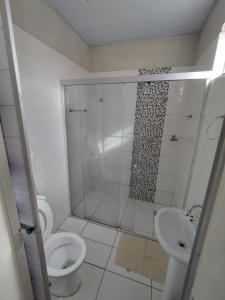 a bathroom with a shower and a toilet and a sink at Hotel Resende in Imperatriz +21 photos