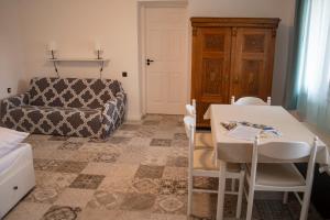 a room with a table and chairs and a bed at Marelle Porta in Veresegyház