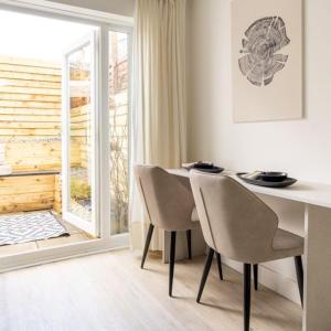 a dining room with a table and chairs and a window at The Bracken's by Ritual Stays in Hemel Hempstead