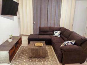 a living room with a brown couch and a coffee table at InTown in Constanţa