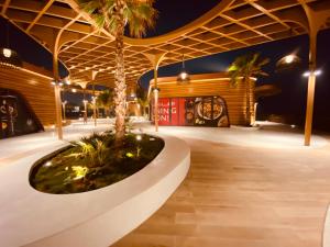 a pavilion with a palm tree in the middle at Private Cottage in Sharjah