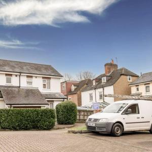 a white van parked in front of some houses at The Bracken's by Ritual Stays in Hemel Hempstead