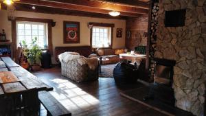 a living room with a fireplace and a stone wall at Uneallika peamaja in Pae