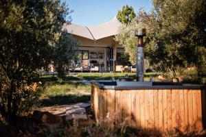 a house with a wooden fence in the yard at Wagyu Mountain Lodge in Paarl