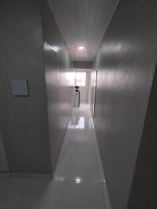 a hallway in a building with a silver wall at Hotel Resende in Imperatriz