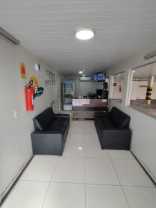 a waiting room with two couches and a fire hydrant at Hotel Resende in Imperatriz