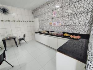 a kitchen with a counter with some food on it at Hotel Resende in Imperatriz