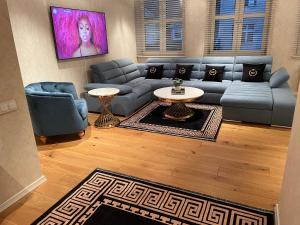 a living room with a couch and a table at Apartament Faltom Gdynia Centrum in Gdynia