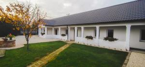 a house with a green lawn in front of it at Marelle Porta in Veresegyház