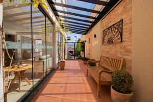 a patio with a bench and a brick wall at Prado Hotel in Amparo