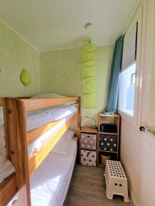 a bedroom with two bunk beds and a window at Ferienpark H05-006 Ferienpark in Heiligenhafen