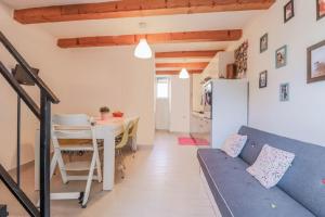 a living room with a blue couch and a table at House Leon in Brtonigla