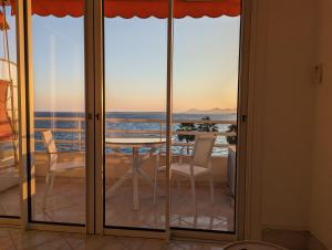 ジュアン・レ・パンにあるSuperbe appartement vue mer panoramiqueの海の景色を望むバルコニー(テーブル、椅子付)