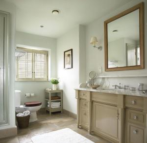 a bathroom with a sink and a toilet and a mirror at Trump International Golf Links & Hotel Doonbeg Ireland in Doonbeg