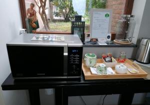 a microwave sitting on a counter with a tray of food at Chambre d'hôte Les Volets Bleus in Namur