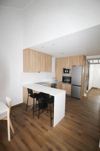 a kitchen with a large white island in a room at Oriente DNA Studios II in Lisbon