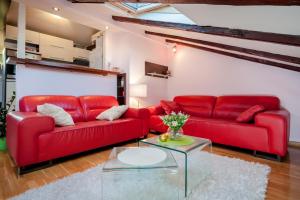 a living room with red couches and a glass table at Apartment Medak Split City Center in Split