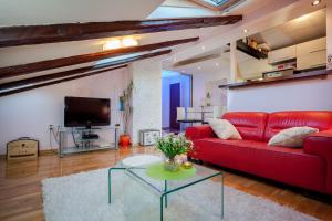 a living room with a red couch and a table at Apartment Medak Split City Center in Split