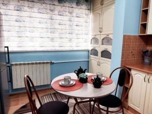 a small table with two chairs and two cups on it at HappyTerra in Almaty