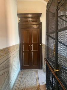 a hallway with a wooden door in a house at Gambara Apartment in Milan