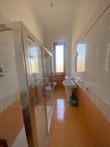 a bathroom with a shower and a sink and a toilet at Gambara Apartment in Milan