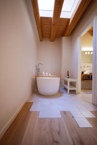 a bathroom with a large tub and a skylight at B&B CA PANISACCO in Valdagno