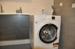 a washer and dryer in a small bathroom at Panorama Garten-Apartment in Marburg in Marburg an der Lahn