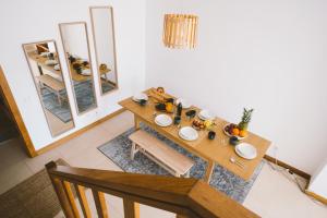 a dining room with a wooden table and mirrors at Best Houses 52 - Baleal Surfside in Ferrel