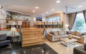 a living room with stairs leading to a dining room at Acropolis Select in Athens