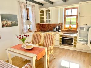 a kitchen with a table and chairs in a room at Bummert Am Hafen 2 Greetsiel in Krummhörn +6 photos