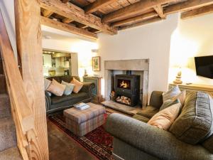a living room with two couches and a fireplace at Sunny Cottage in Darlington